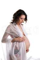 Charming pregnant woman posing stroking her belly
