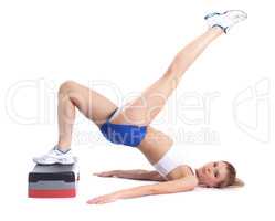 Image of flexible young girl exercising on stepper