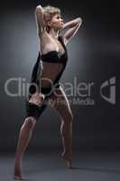 Graceful girl dancing in black erotic lingerie