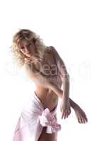 Curly blonde posing topless with downcast eyes