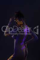 Side view of slender girl with luminous UV pattern