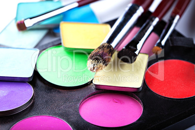 Makeup brushes with colorful eyeshadows, close-up