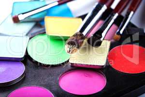 Makeup brushes with colorful eyeshadows, close-up