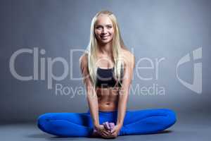 Merry muscular blonde posing in lotus posture
