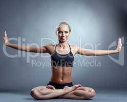 Beautiful slim woman doing yoga in studio