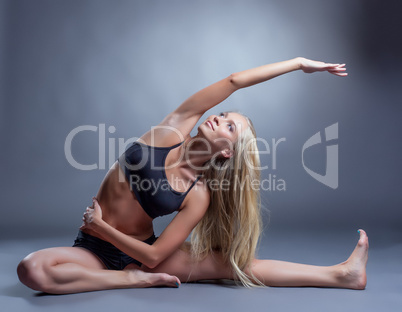 Image of smiling young woman doing stretching