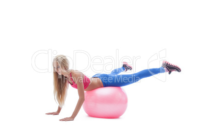 Image of sporty blonde exercising on fitness ball