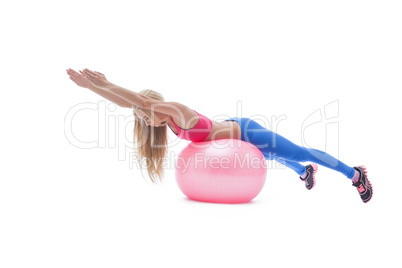 Beautiful fitness trainer exercising with ball