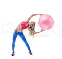 Beautiful slim woman exercising with fitness ball