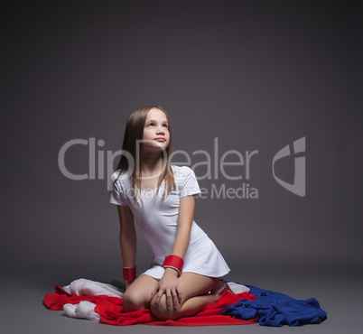 Pretty little gymnast posing with colorful cloth