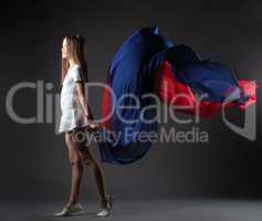 Graceful little athlete posing with colorful cloth