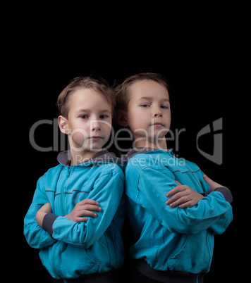 Portrait of adorable twin boys isolated on black