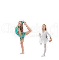 Two cute artistic gymnasts warming up in studio