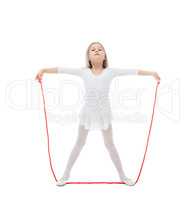 Charming little gymnast posing with skipping rope