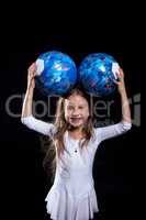 Happy little girl posing with gymnastic balls
