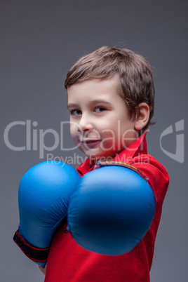 Slyly smiling young boxer posing looking at camera