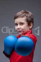 Slyly smiling young boxer posing looking at camera