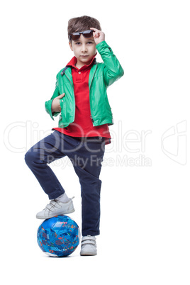 Athletic cute boy posing with ball in studio