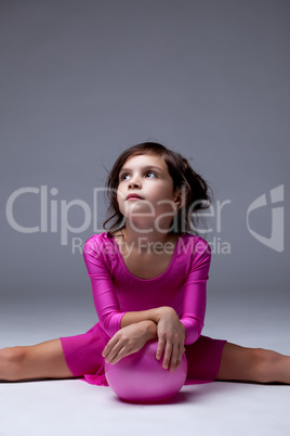 Thoughtful young girl posing with gymnastic ball