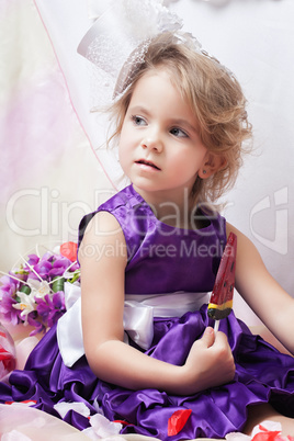 Image of fancy dressed girl posing with lollipop