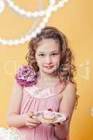 Portrait of curly elegant girl posing with cake