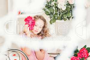 Portrait of dreamy beautiful girl posing with flower
