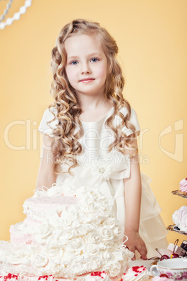 Smiling birthday girl posing with tasty cake