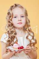 Portrait of lovely curly girl posing with cake