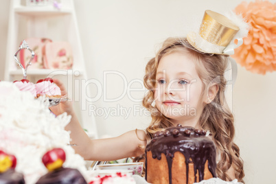 Smiling little girl posing in golden hat