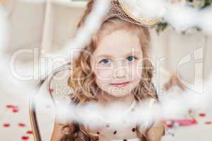Portrait of adorable little girl looking at camera