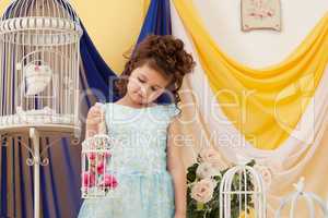 Adorable little girl posing in decorated studio