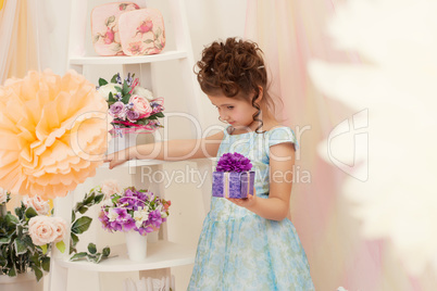 Beautiful girl posing in smart dress with gift box