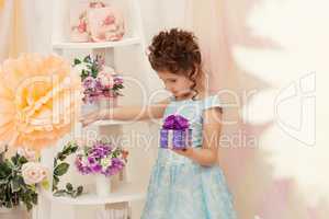 Beautiful girl posing in smart dress with gift box