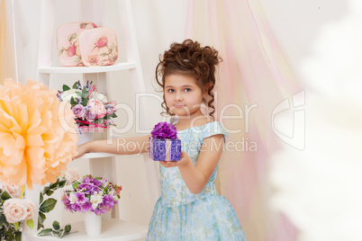Pretty girl posing with gift in vintage interior