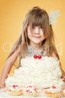 Portrait of funny girl posing with birthday cake