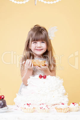 Funny little sweet tooth posing with eclair