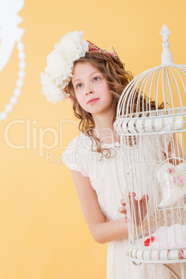 Pretty young girl posing in elegant dress and hat