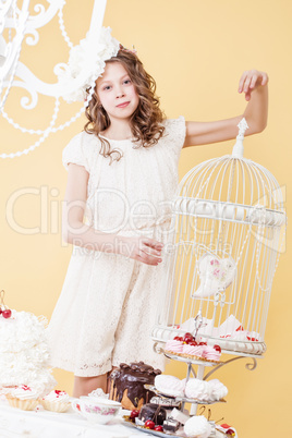 Beautiful young girl posing with decorative cage