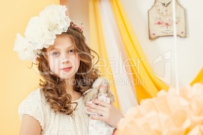 Attractive young girl posing with doll