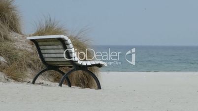 White wooden bench on the beach