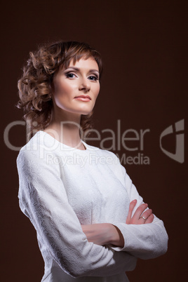 Beautiful middle-aged model posing in white blouse