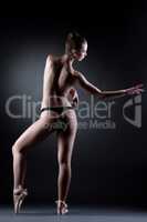 Graceful seminude dancer posing in studio