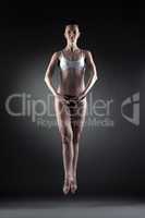 Image of beautiful slim dancer posing in jump