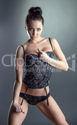 Portrait of excited young girl advertises lingerie