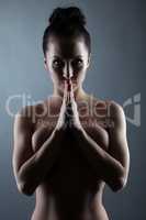 Portrait of naked slim brunette posing in studio