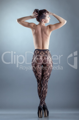 Naked girl posing in black translucent pantyhose