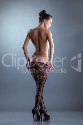 Seductive nude woman posing in translucent tights