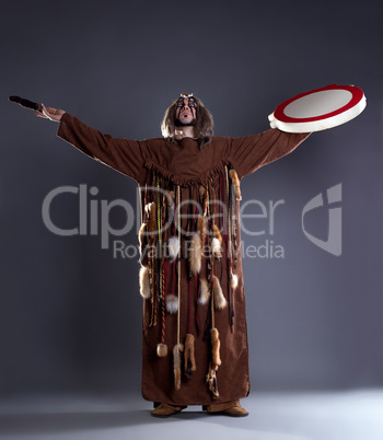 Image of shaman posing with tambourine in studio