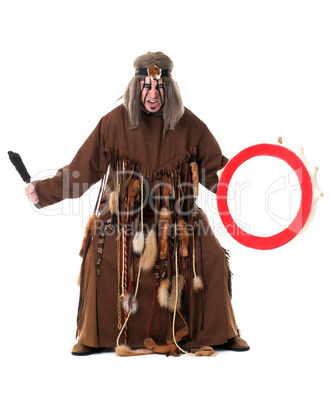 Aggressive middle-aged shaman posing at camera