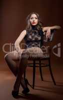 Curvy woman posing in lingerie sitting on chair